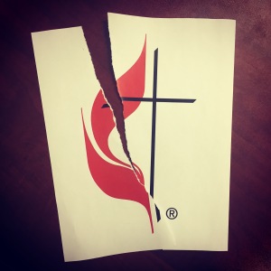 United Methodist cross and flame logo torn in two